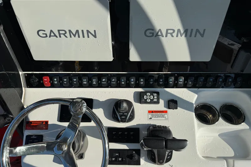 Slide: The Image of Control panel of 2021 Sea Hunt Gamefish 30 with Garmin displays and steering wheel. - 5