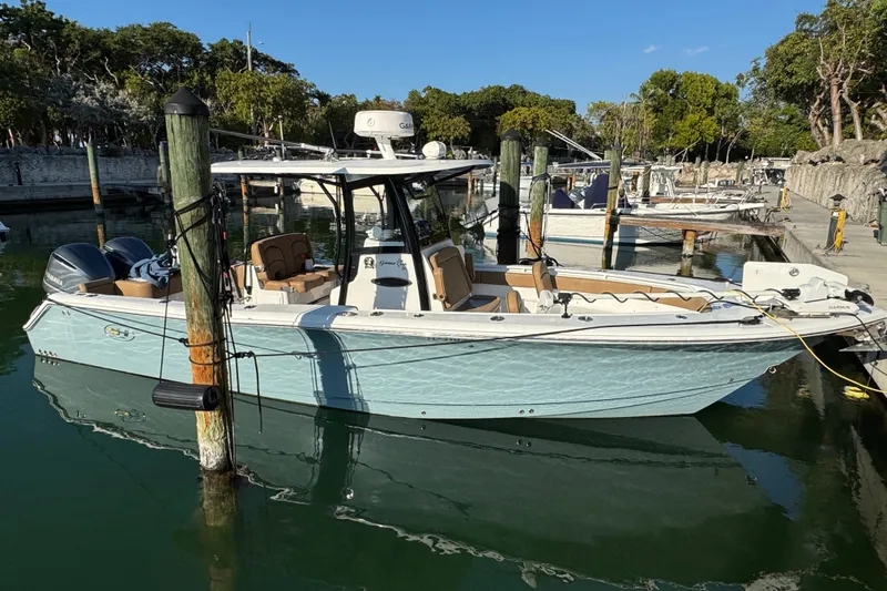 Slide: The Image of 2021 Sea Hunt Gamefish 30 Forward Seating boat docked in a marina. - 6