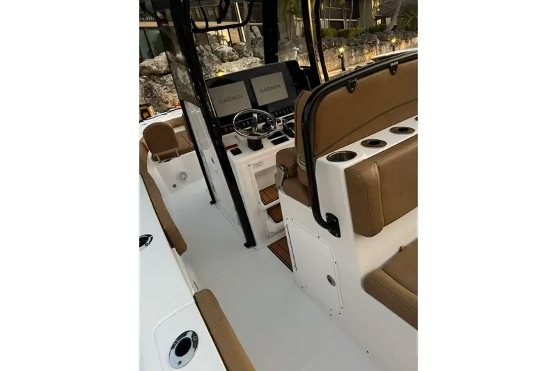 Slide: The Image of 2021 Sea Hunt Gamefish 30 Forward Seating boat interior with Garmin displays and brown seating. - 9