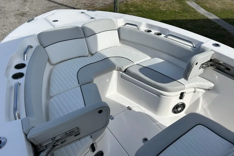 Slide: The Image of 2022 Sea Fox 228 Commander boat interior with cushioned seating and cup holders. - 11