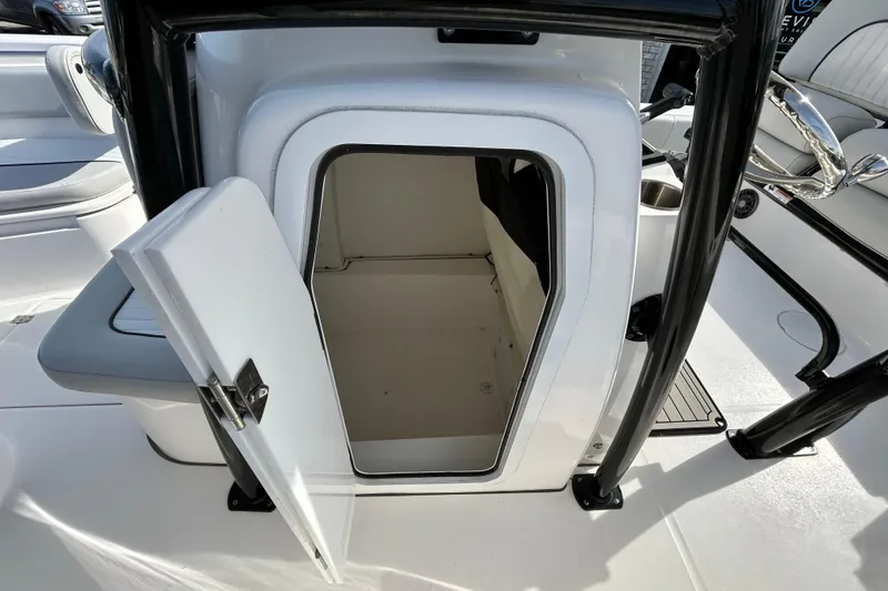 Slide: The Image of 2022 Sea Fox 228 Commander boat storage compartment with open door, showcasing interior space. - 18