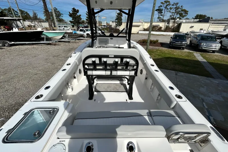 Slide: The Image of 2022 Sea Fox 228 Commander boat interior with seating and console, parked outdoors. - 23