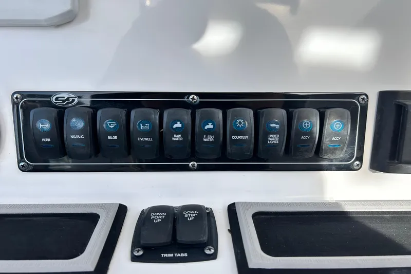 Slide: The Image of Control panel of a 2022 Sea Fox 228 Commander boat with labeled switches. - 26