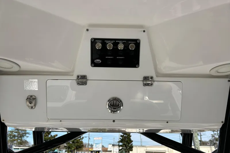 Slide: The Image of 2022 Sea Fox 228 Commander control panel with switches and storage compartment. - 27