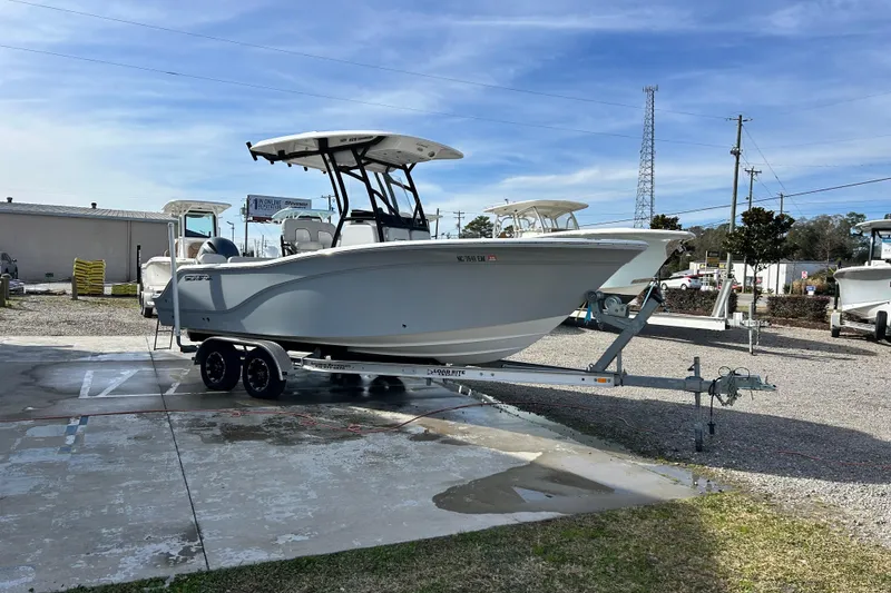 Slide: The Image of 2022 Sea Fox 228 Commander boat on trailer, parked outdoors under clear sky. - 7