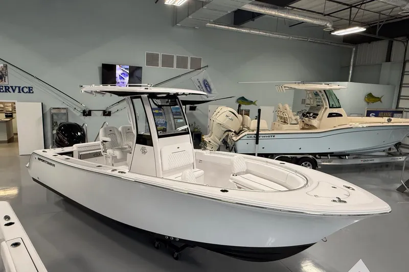 The Image of 2026 Sportsman Open 232 Center Console boat displayed in showroom setting. - 0