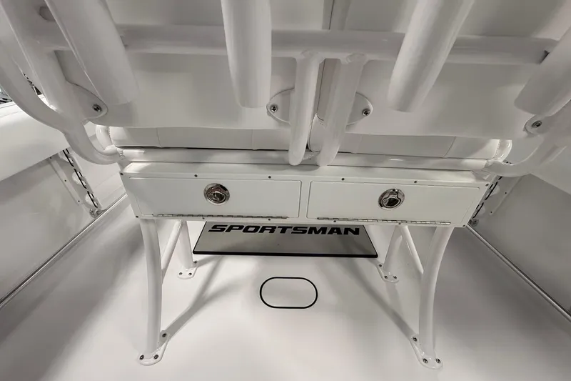 Slide: The Image of 2026 Sportsman Open 232 Center Console interior with storage compartments and logo. - 10