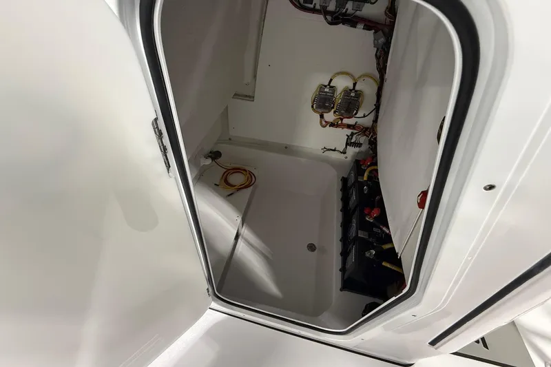 Slide: The Image of 2026 Sportsman Open 232 Center Console interior wiring and battery compartment. - 11