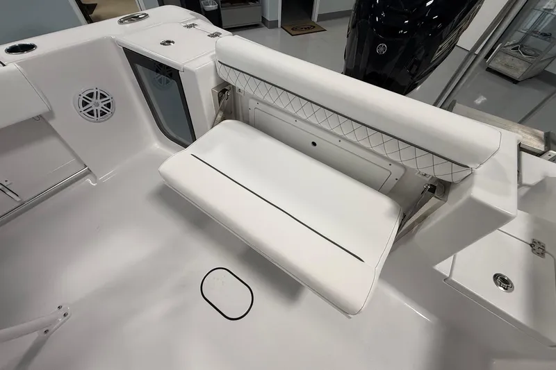 Slide: The Image of 2026 Sportsman Open 232 Center Console boat interior with foldable seating and speaker. - 13