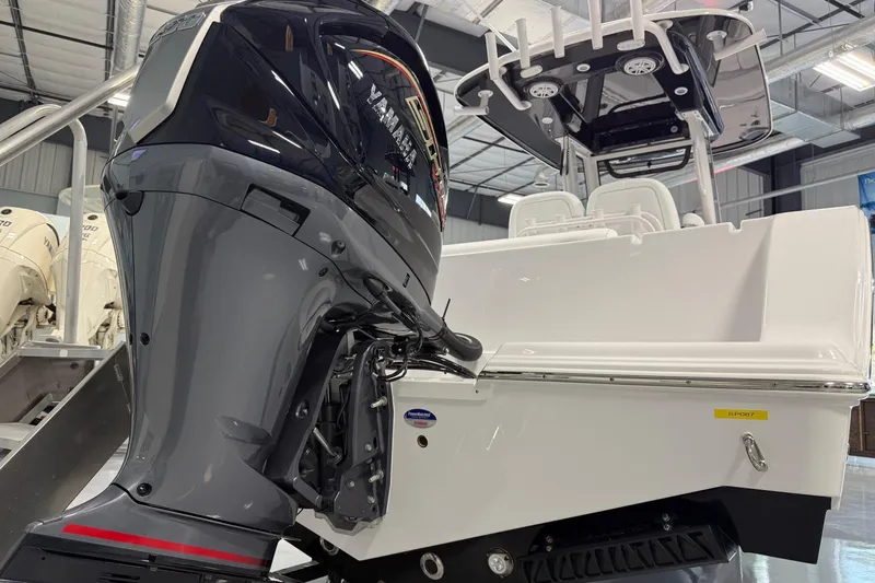 Slide: The Image of 2026 Sportsman Open 232 Center Console boat with Yamaha outboard motor in showroom. - 3