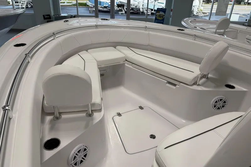 Slide: The Image of 2026 Sportsman Open 232 Center Console boat interior with white seating and storage. - 7