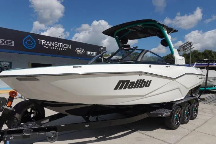 Slide: The Image of 2022 Malibu Wakesetter 25 LSV boat displayed at Transition Watersports dealership. - 1