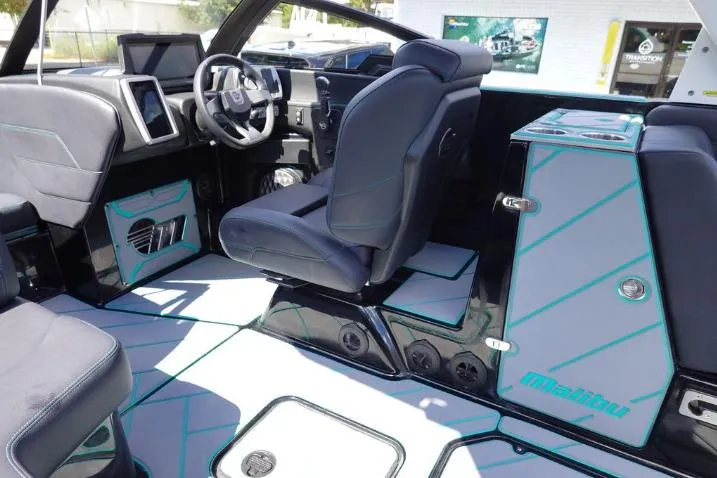 Slide: The Image of Interior of 2022 Malibu Wakesetter 25 LSV boat with modern seating and dashboard. - 10