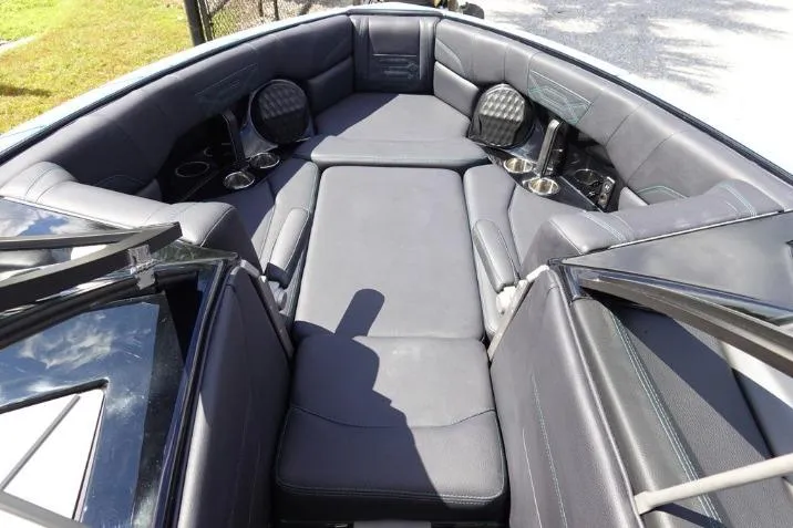 Slide: The Image of 2022 Malibu Wakesetter 25 LSV boat interior with cushioned seating and cup holders. - 17