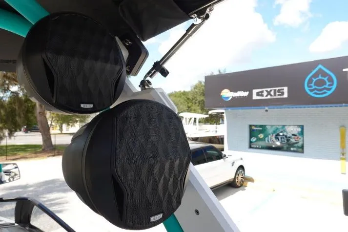 Slide: The Image of 2022 Malibu Wakesetter 25 LSV boat speakers at a dealership with signage in the background. - 18