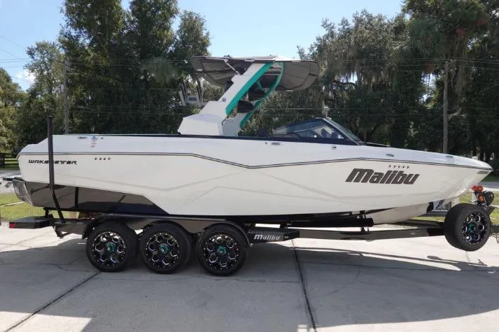 Slide: The Image of 2022 Malibu Wakesetter 25 LSV boat on trailer, side view, outdoors. - 3