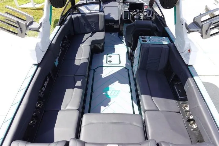 Slide: The Image of 2022 Malibu Wakesetter 25 LSV interior with spacious seating and modern dashboard. - 9