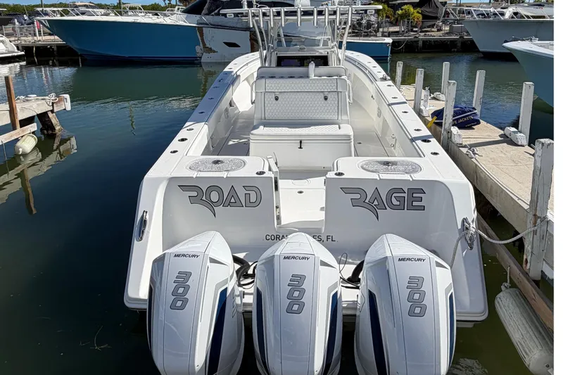 Slide: The Image of 2021 SeaHunter 35 Tournament boat with triple Mercury 300 engines docked in marina. - 11