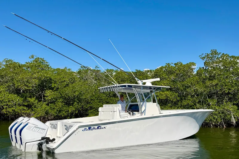 Slide: The Image of 2021 SeaHunter 35 Tournament boat with triple engines on calm water. - 3