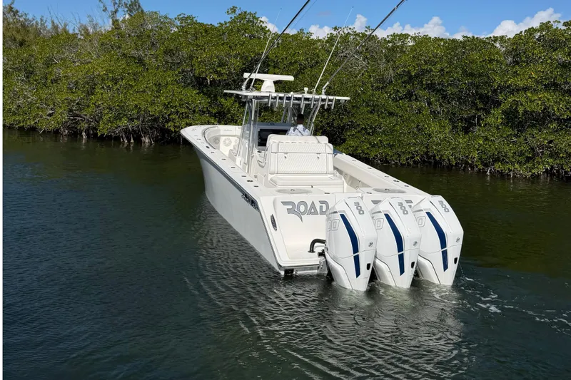 Slide: The Image of 2021 SeaHunter 35 Tournament boat with triple engines in a serene waterway setting. - 4