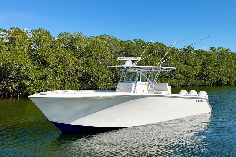 Slide: The Image of 2021 SeaHunter 35 Tournament boat on calm water with lush green mangroves. - 6