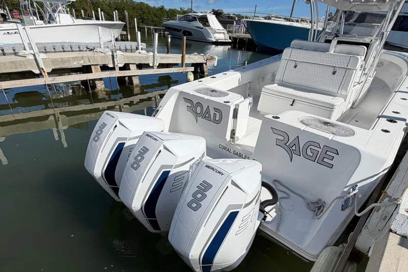 Slide: The Image of 2021 SeaHunter 35 Tournament boat docked with triple outboard engines. - 7