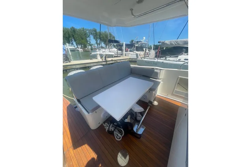 Slide: The Image of 2015 Faeton Formentera boat interior with seating and table, docked at marina. - 15