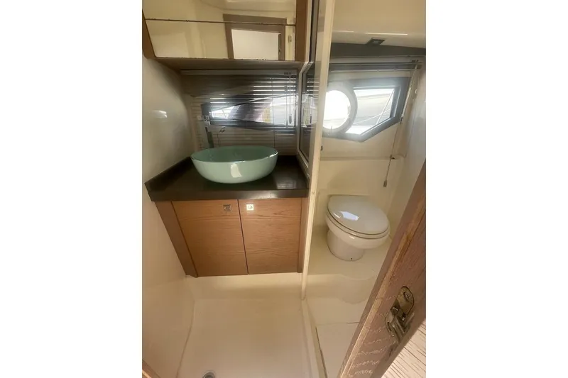 Slide: The Image of 2015 Faeton Formentera yacht bathroom with modern sink and porthole window. - 17
