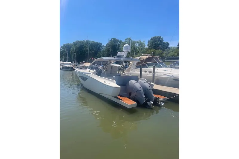 Slide: The Image of 2015 Faeton Formentera boat docked with twin outboard motors on a sunny day. - 22