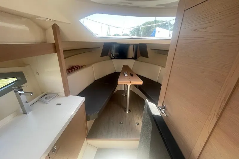 Slide: The Image of Interior of 2015 Faeton Formentera boat with modern seating and compact kitchenette. - 29