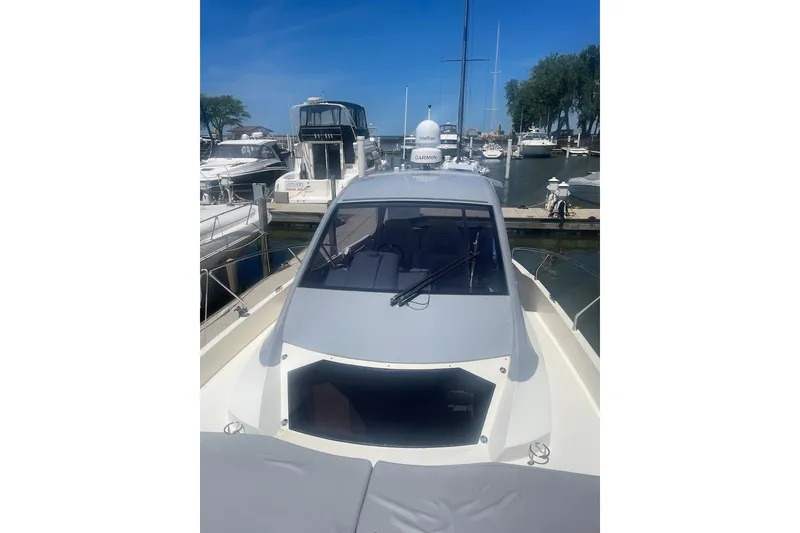 Slide: The Image of 2015 Faeton Formentera boat docked at marina under clear blue sky. - 3
