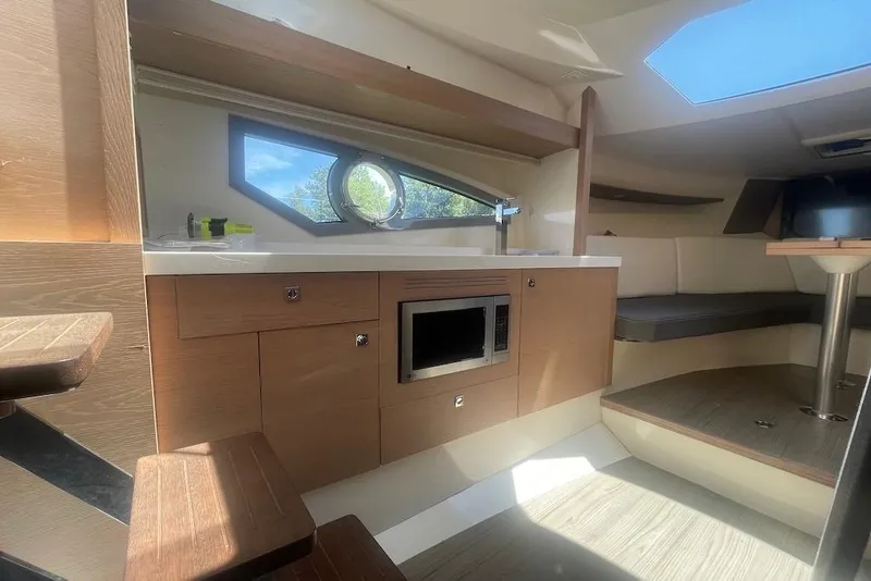Slide: The Image of Interior of 2015 Faeton Formentera boat with kitchenette and seating area. - 30