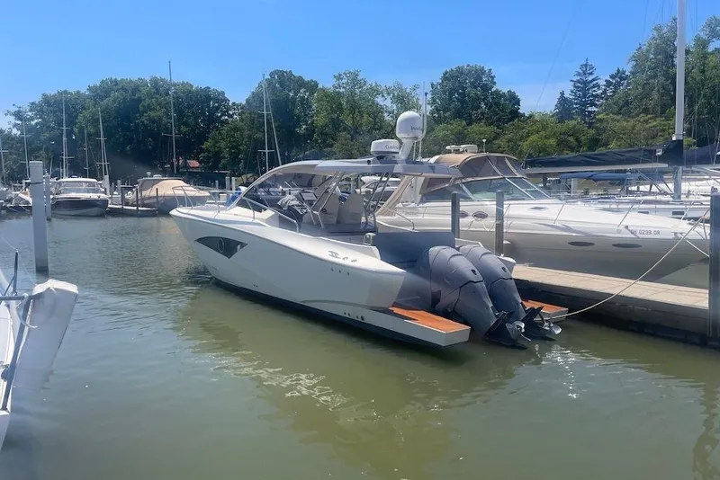 Slide: The Image of 2015 Faeton Formentera boat docked at a marina with twin outboard engines. - 31