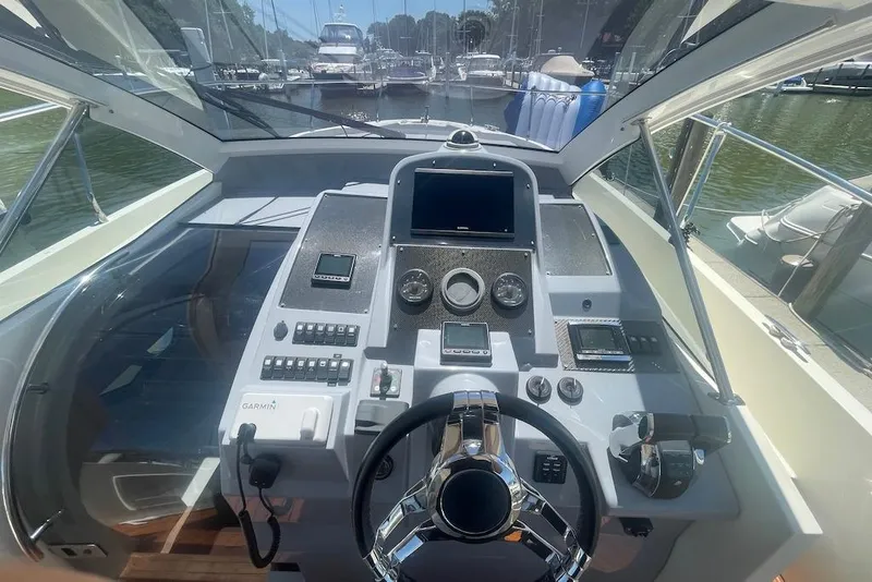 Slide: The Image of Cockpit view of 2015 Faeton Formentera boat with modern navigation controls and steering wheel. - 7