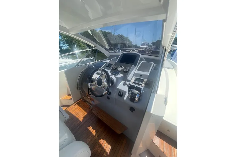 Slide: The Image of Helm of 2015 Faeton Formentera boat with modern controls and wooden flooring. - 9