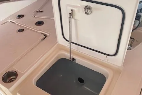 Slide: The Image of 2026 Boston Whaler 250 Dauntless boat interior with open storage compartment. - 10