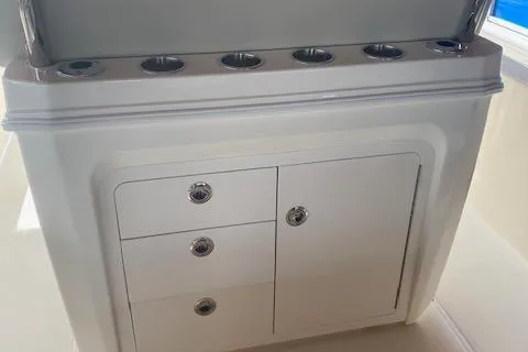 Slide: The Image of 2026 Boston Whaler 250 Dauntless boat storage compartment with cup holders. - 9