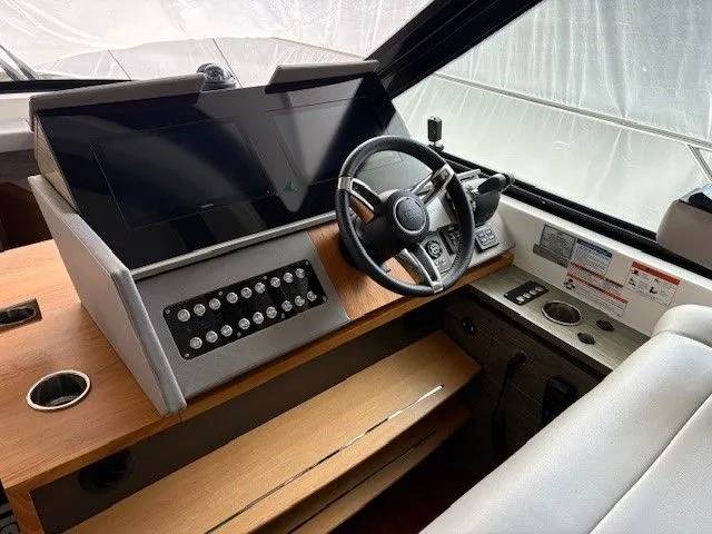 Slide: The Image of Interior view of Tiara Yachts C49 Coupe 2020 cockpit. - 16