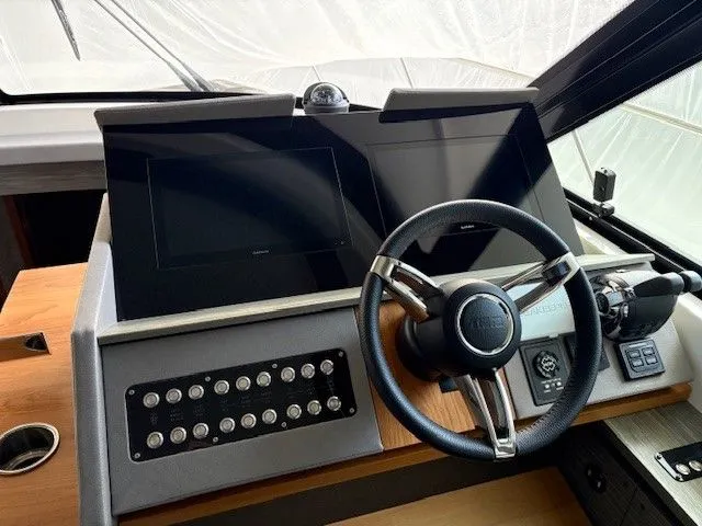 Slide: The Image of 2020 Tiara Yachts C49 Coupe cockpit with modern controls. - 18