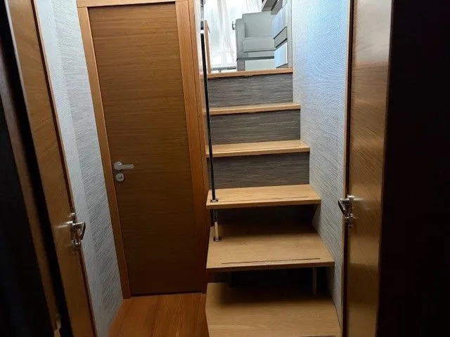 Slide: The Image of Interior of 2020 Tiara Yachts C49 Coupe with wooden staircase. - 25