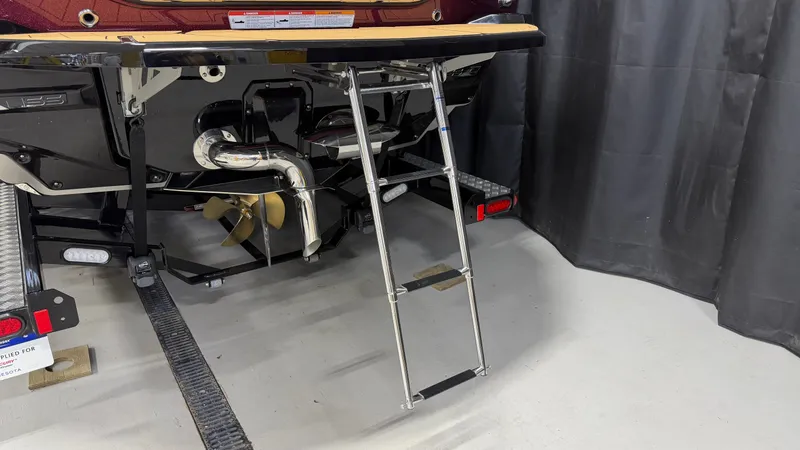 Slide: The Image of Rear of a Nautique Super Air Nautique G23 with a retractable swim ladder. - 11