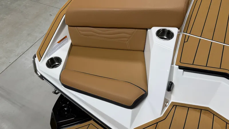 Slide: The Image of Seating area with brown upholstery and cup holders on a boat. - 14