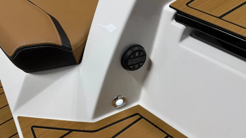 Slide: The Image of Close-up of a boat control panel with brown upholstery and wood flooring. - 15