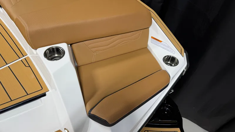 Slide: The Image of Seating area with brown upholstery and cup holders on a boat. - 16