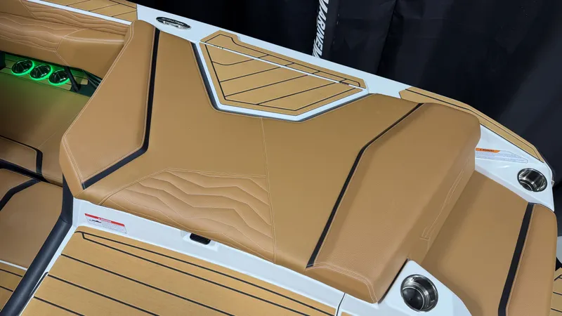 Slide: The Image of Rear view of a Nautique Super Air Nautique G23 with brown upholstery and cup holders. - 19