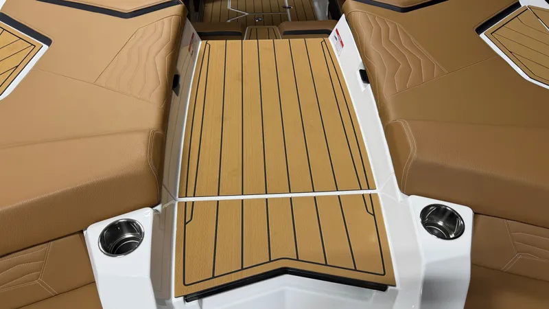 Slide: The Image of The image shows the deck of a 2026 Nautique Super Air Nautique G23 with brown upholstery and cup holders. - 21