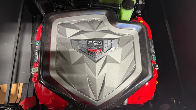 Slide: The Image of Engine cover of a PCM motor with geometric design and logo. - 23