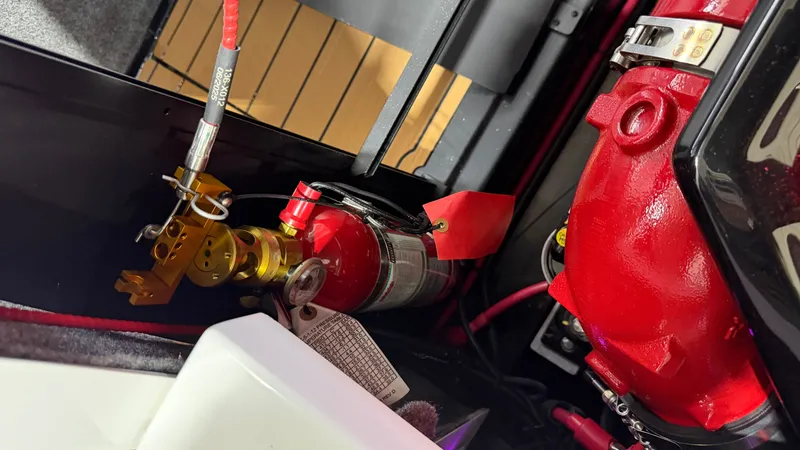 Slide: The Image of Close-up of a fire extinguisher and a red engine in a boat. - 24