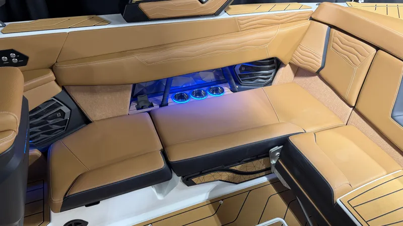 Slide: The Image of Interior of the Nautique Super Air Nautique G23 with luxurious brown upholstery and blue lighting. - 25