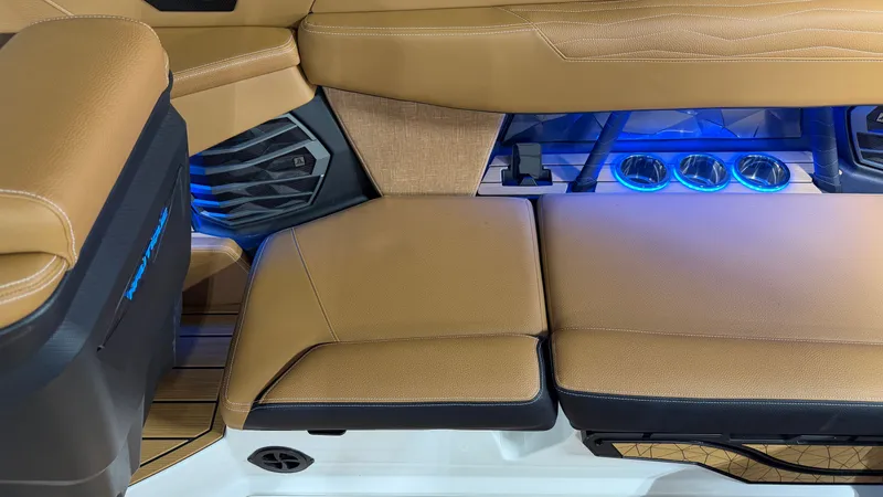 Slide: The Image of Interior of the Nautique Super Air Nautique G23 with brown upholstery and blue LED lighting. - 26